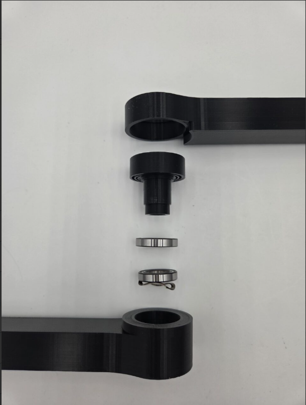 Exploded view of the redesigned distal arm